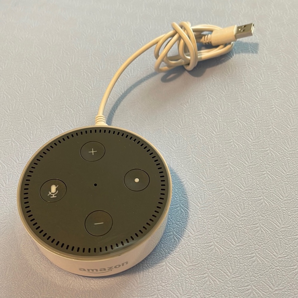 Amazon Echo dot white electronic with USB to micro cord.